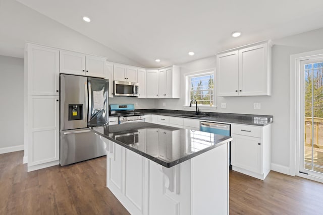 kitchen with stainless steel appliances, a wealth of natural light, a sink, and white cabinetry