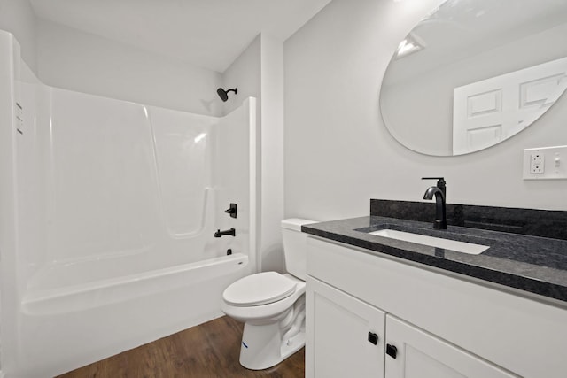 bathroom with vanity, shower / bathtub combination, toilet, and wood finished floors