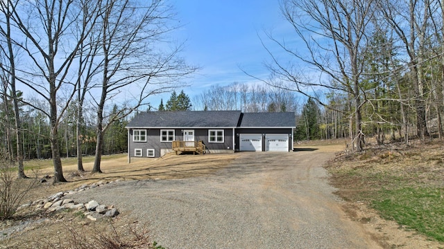 ranch-style house with a garage, a shingled roof, and dirt driveway