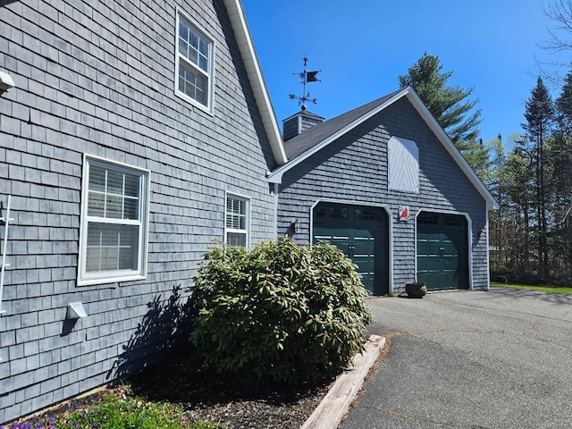view of home's exterior featuring a garage and driveway