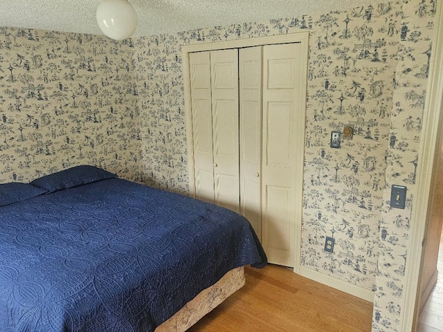193 N Rd, Detroit, ME 04929 - bedroom featuring wallpapered walls, wood finished floors, baseboards, and a closet