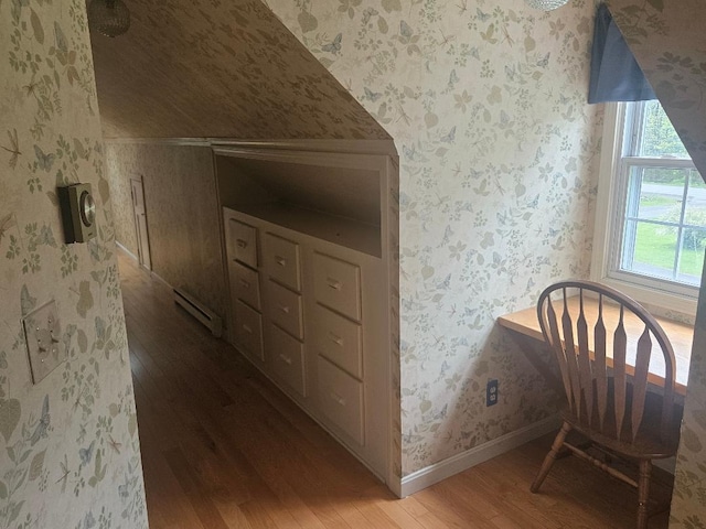 193 N Rd, Detroit, ME 04929 - bedroom featuring wood finished floors, a baseboard heating unit, wallpapered walls, baseboards, and vaulted ceiling