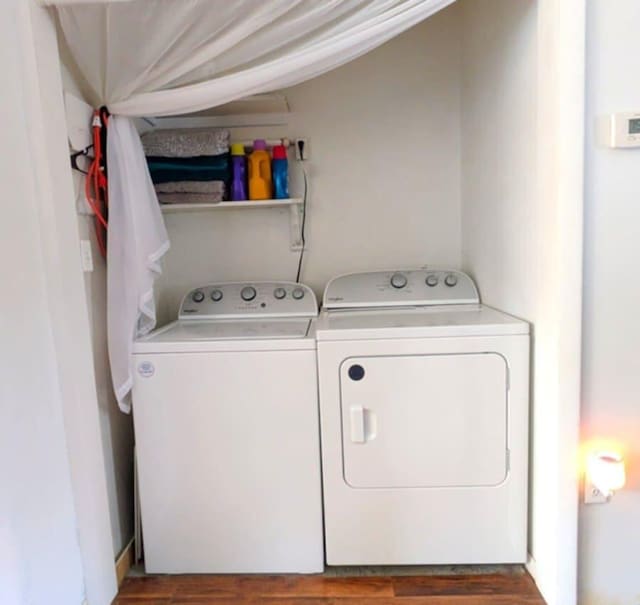 washroom with laundry area, wood finished floors, and washer and dryer