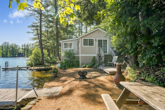 92 Red Gate Ln, Acton, ME 04001 - exterior space featuring a water view, a fire pit, a boat dock, and entry steps