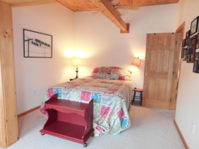 92 Red Gate Ln, Acton, ME 04001 - carpeted bedroom featuring a ceiling fan, baseboards, lofted ceiling with beams, and wood ceiling