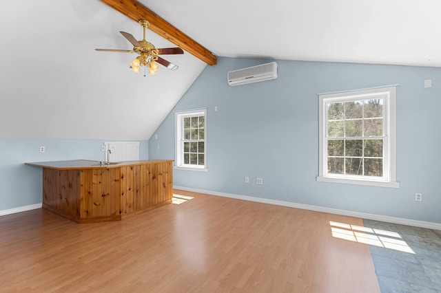 additional living space with wood finished floors, a healthy amount of sunlight, an AC wall unit, vaulted ceiling with beams, and a ceiling fan