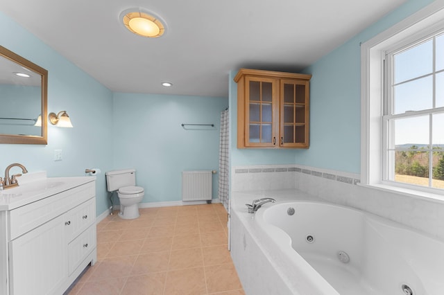 bathroom featuring vanity, radiator heating unit, a wealth of natural light, and toilet