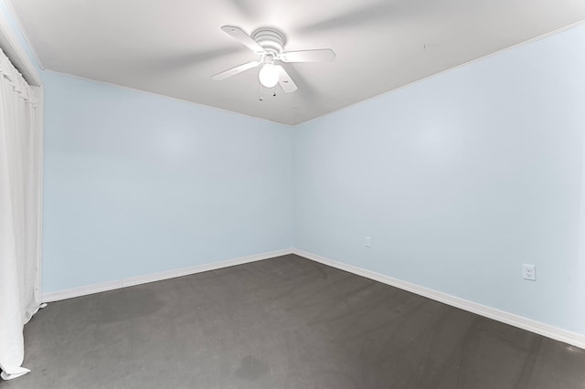 spare room featuring baseboards, ceiling fan, and dark colored carpet