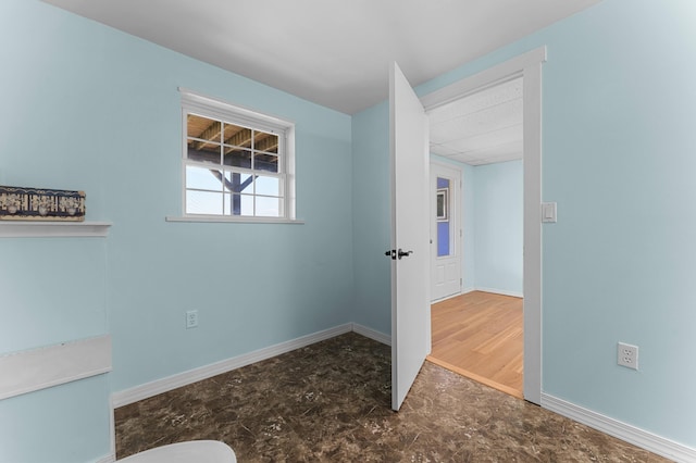 unfurnished room featuring baseboards and a paneled ceiling