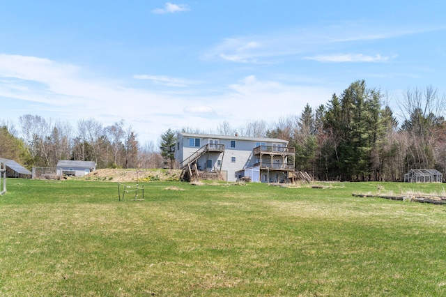 view of yard featuring stairs and a deck