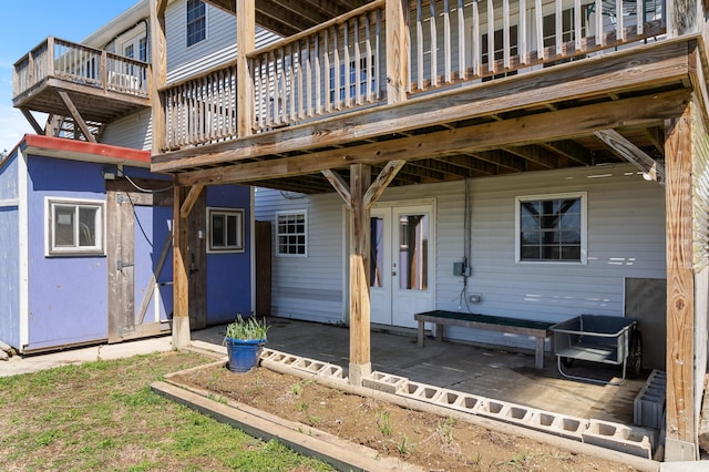 rear view of house with a patio and a wooden deck