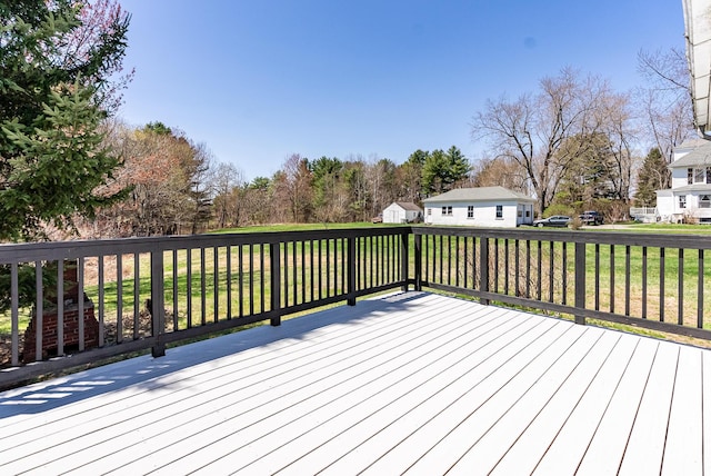 wooden terrace featuring a lawn and a residential view
