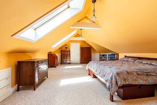 carpeted bedroom featuring lofted ceiling with skylight