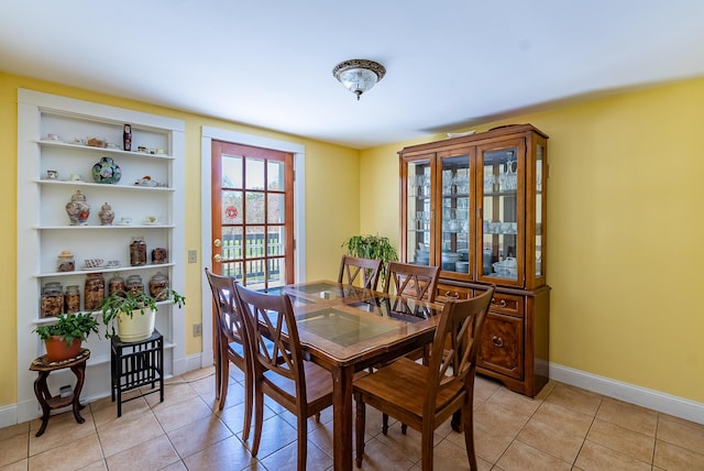 dining room with baseboards and light tile patterned floors