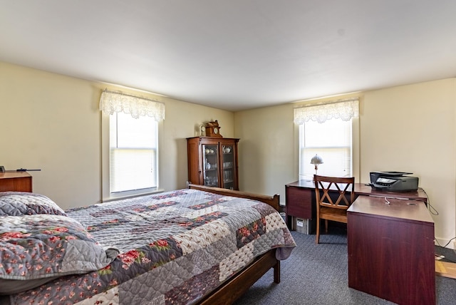 bedroom featuring carpet flooring and multiple windows