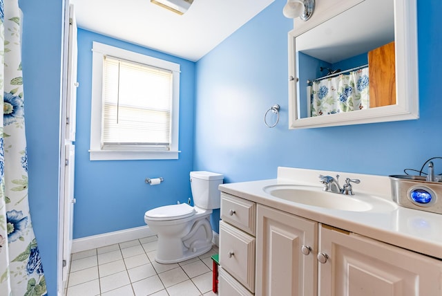 bathroom with toilet, baseboards, tile patterned flooring, and vanity