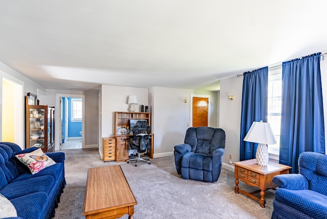 living room featuring carpet floors and baseboards