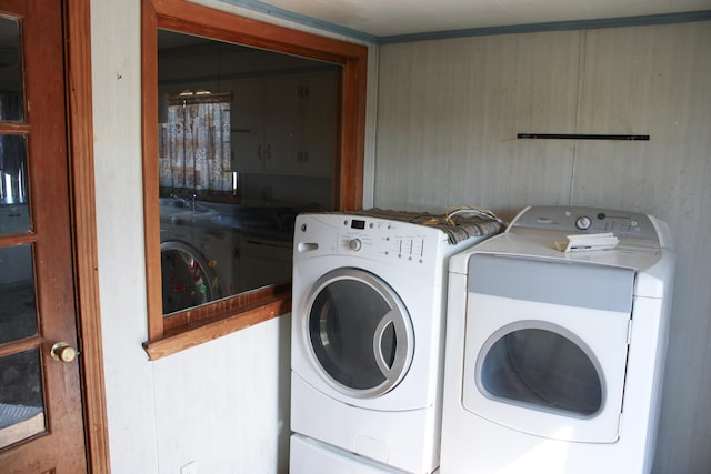 clothes washing area featuring laundry area and washer and dryer