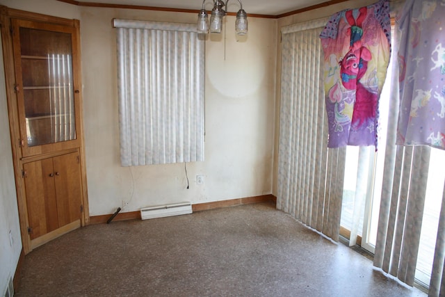 spare room with baseboards, ornamental molding, speckled floor, and a baseboard radiator