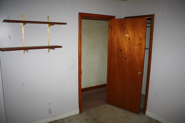 carpeted spare room featuring baseboards
