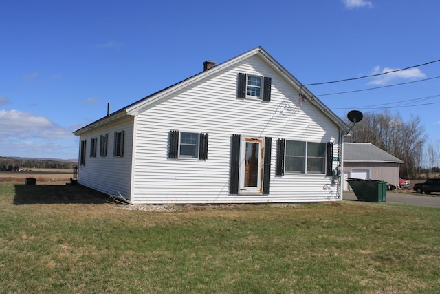 exterior space with a lawn and a chimney