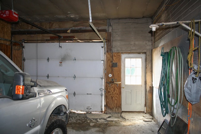 garage featuring washer and dryer and a garage door opener