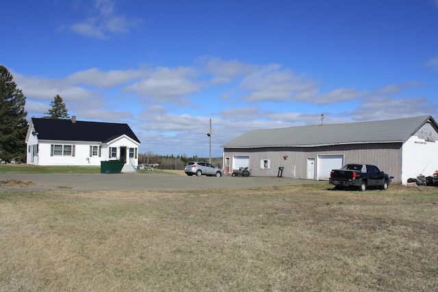 exterior space featuring an outdoor structure and a detached garage