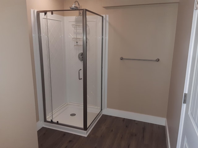 72 Main St, Orono, ME 04473 - bathroom featuring baseboards, a stall shower, and wood finished floors