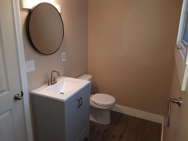 72 Main St, Orono, ME 04473 - half bath with vanity, baseboards, wood finished floors, and toilet