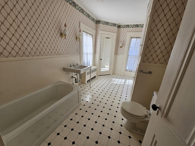 72 Main St, Orono, ME 04473 - bathroom featuring wainscoting, radiator, toilet, wallpapered walls, and tile patterned floors