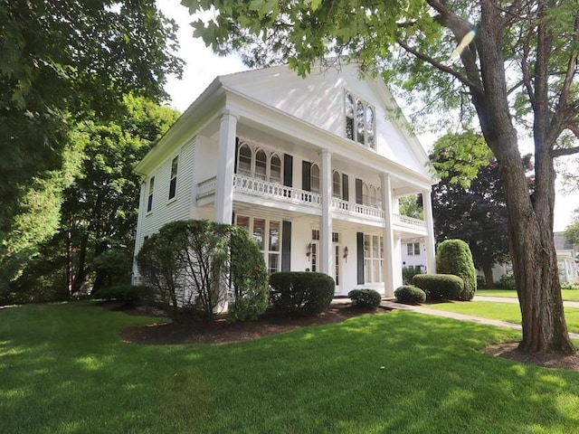 72 Main St, Orono, ME 04473 - neoclassical / greek revival house with a porch, a balcony, and a front lawn