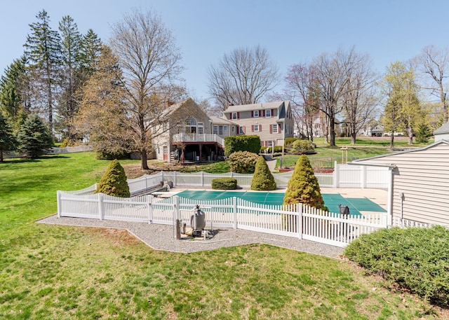 view of swimming pool with a lawn, a fenced in pool, and a fenced backyard