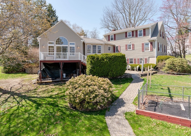 back of house featuring a lawn, fence, a wooden deck, and stairway