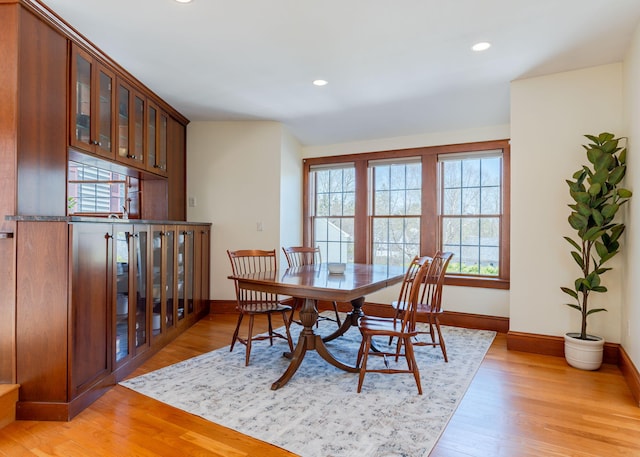dining space featuring light wood-type flooring, recessed lighting, and baseboards