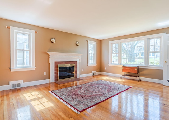 living room featuring plenty of natural light, hardwood / wood-style flooring, and visible vents