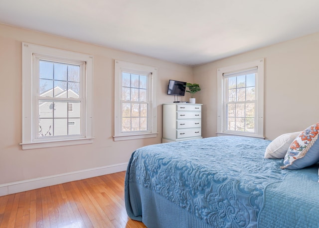 bedroom featuring baseboards and hardwood / wood-style floors