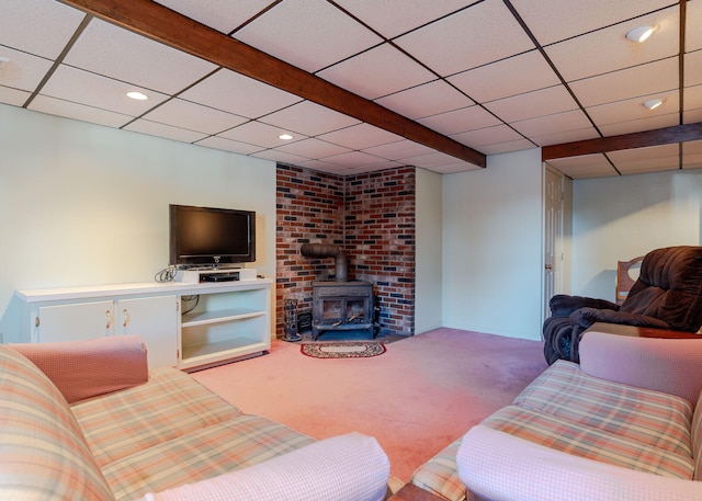 carpeted living room with recessed lighting, a wood stove, and a drop ceiling