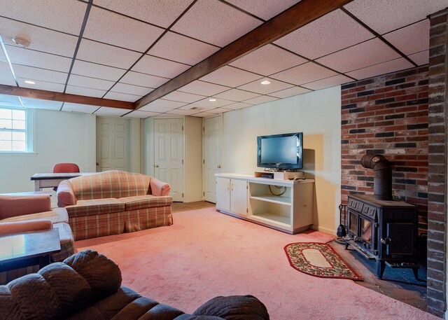 living area featuring light colored carpet, a wood stove, a drop ceiling, and recessed lighting