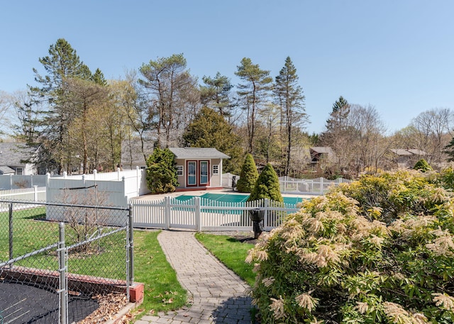 view of pool with a fenced in pool, a storage structure, french doors, an outdoor structure, and fence private yard