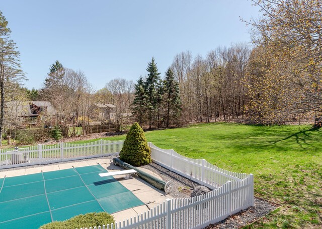 view of pool featuring a yard and fence