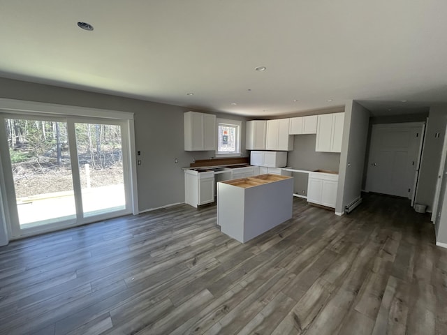 1215 Milton Mills Rd, Acton, ME 04001 - kitchen featuring recessed lighting, a kitchen island, white cabinets, and wood finished floors
