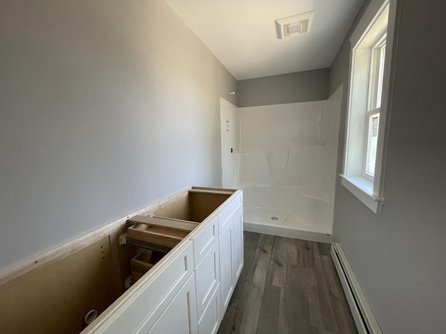 1215 Milton Mills Rd, Acton, ME 04001 - full bathroom with a baseboard heating unit, walk in shower, visible vents, and wood finished floors