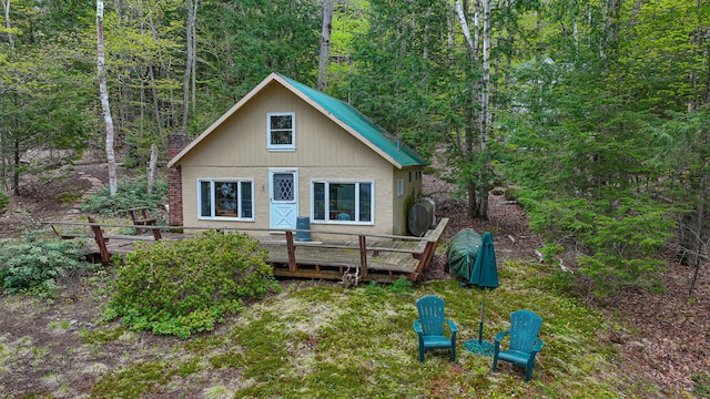 65 Pinecroft Rd, Harrison, ME 04040 - rear view of house featuring a deck and a wooded view