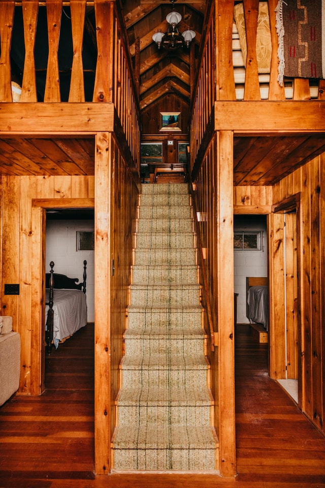 65 Pinecroft Rd, Harrison, ME 04040 - stairs featuring wooden walls, wood-type flooring, and vaulted ceiling