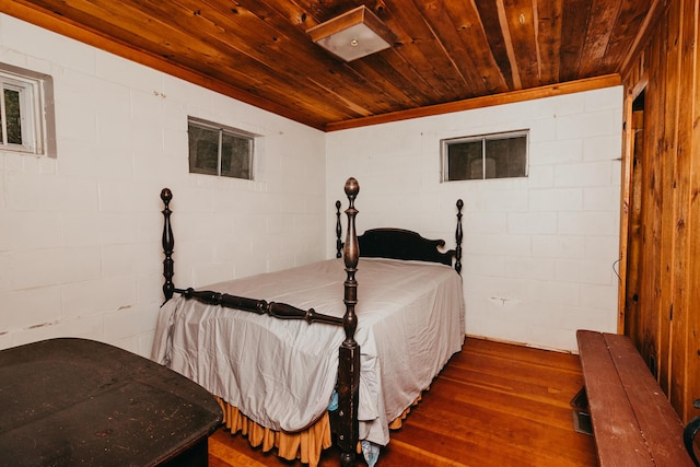 65 Pinecroft Rd, Harrison, ME 04040 - bedroom featuring dark wood-type flooring, wood ceiling, and concrete block wall