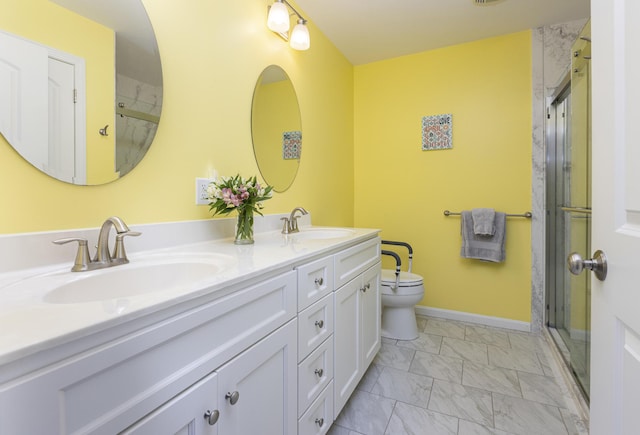 7 Berry Ln Unit 101, Biddeford, ME 04005 - full bath with marble look tiles, double vanity, toilet, a shower with shower door, and baseboards