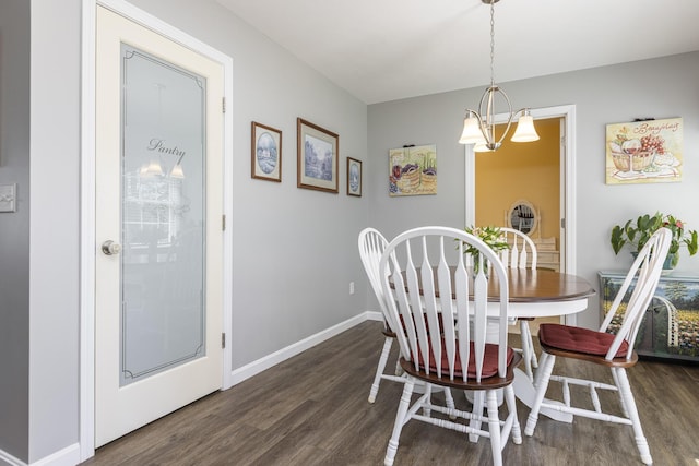 7 Berry Ln Unit 101, Biddeford, ME 04005 - dining area featuring dark wood-type flooring, baseboards, and a chandelier