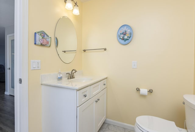 7 Berry Ln Unit 101, Biddeford, ME 04005 - bathroom featuring toilet, vanity, and baseboards