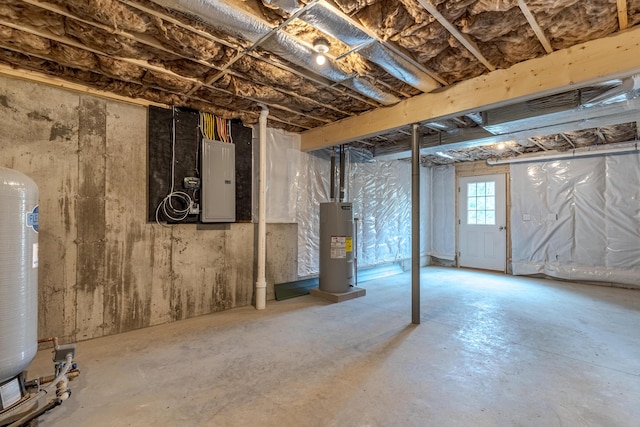 below grade area featuring water heater and electric panel
