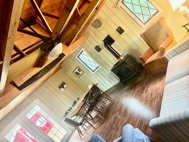 living area featuring a wood stove and wood finished floors
